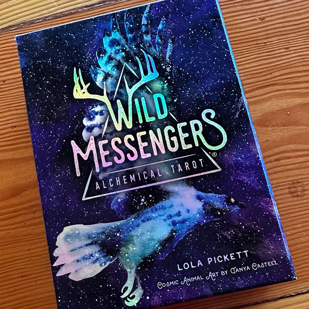 Wild Messengers® Alchemical Tarot holographic box sample on wood floor, Costa Rica